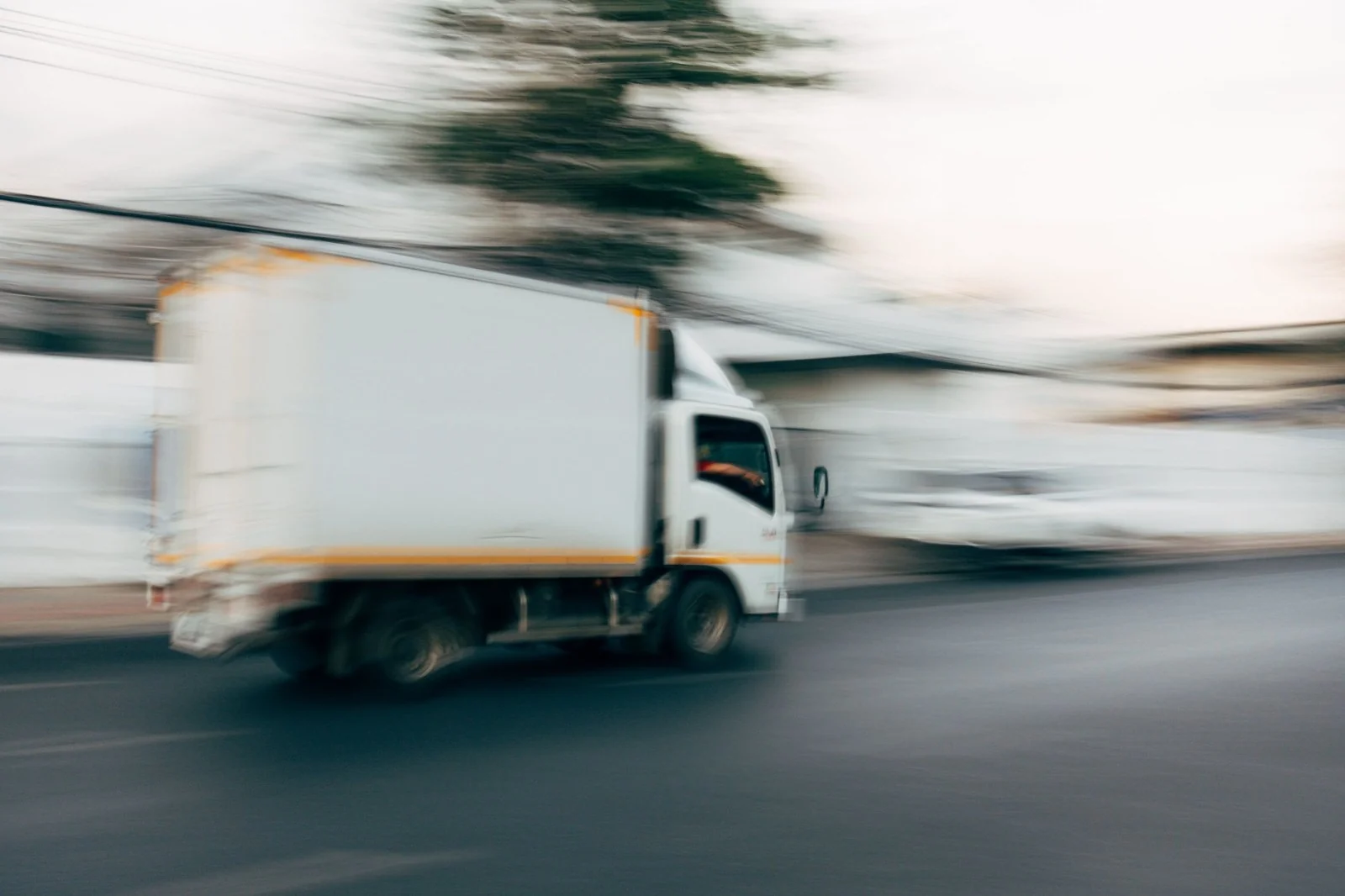 Moving truck in motion on a quiet street