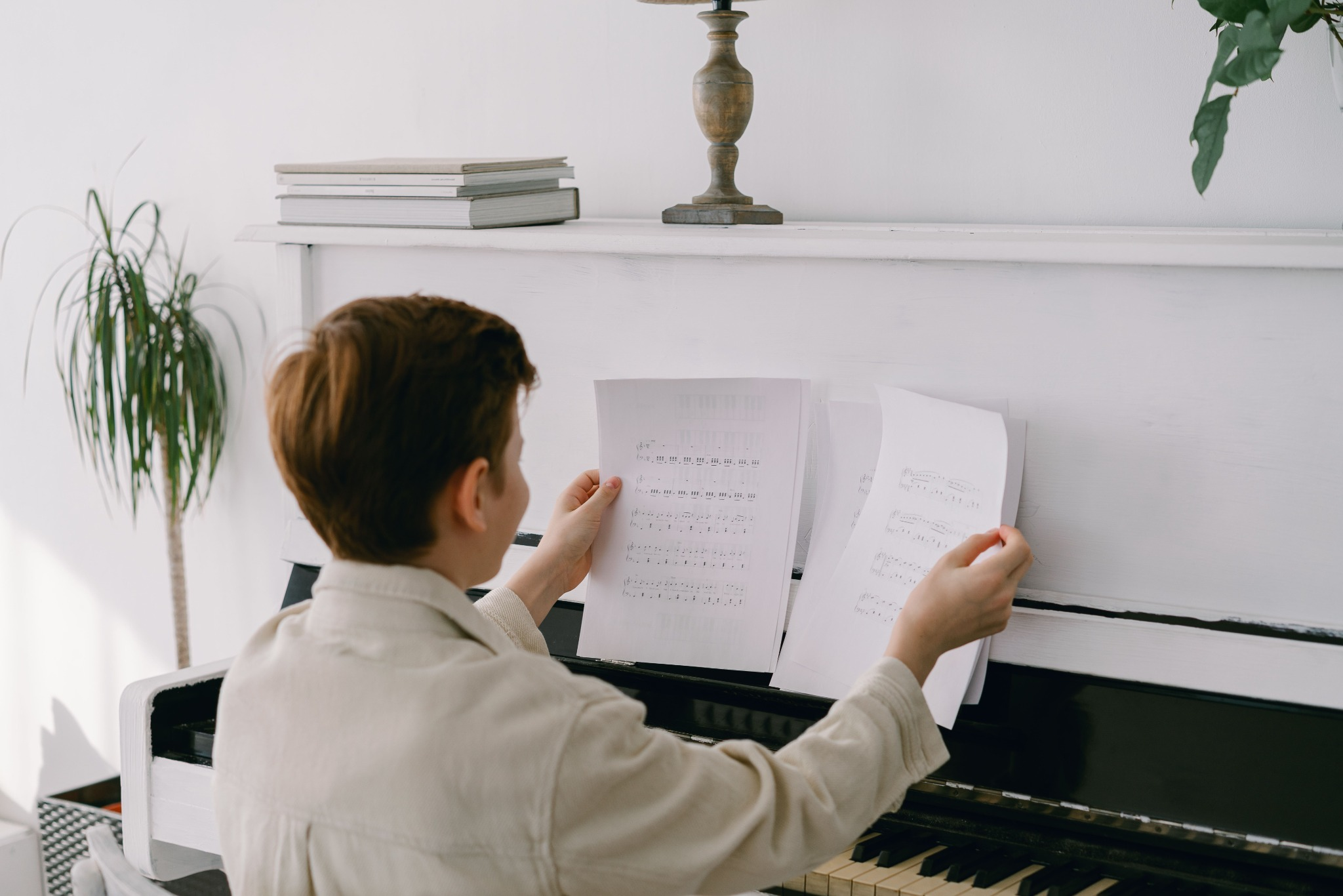 A young pianist learning with sheet music